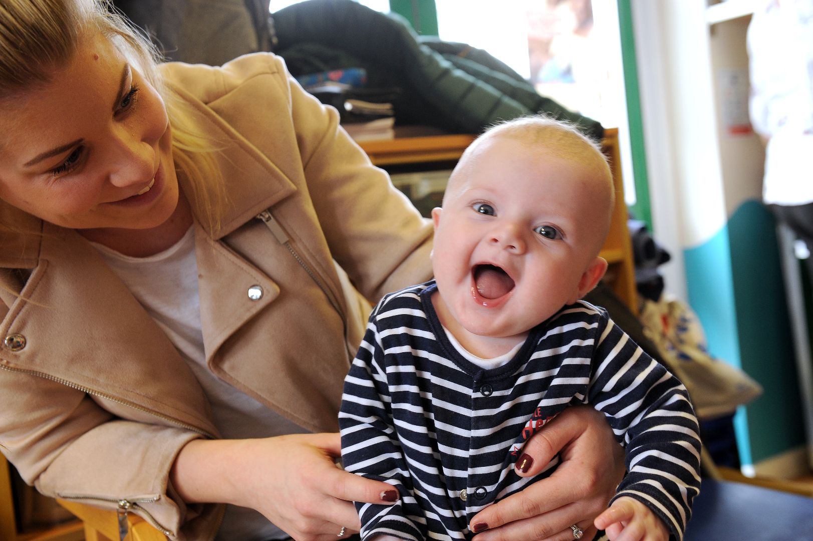 Photograph of a mother and her baby laughing