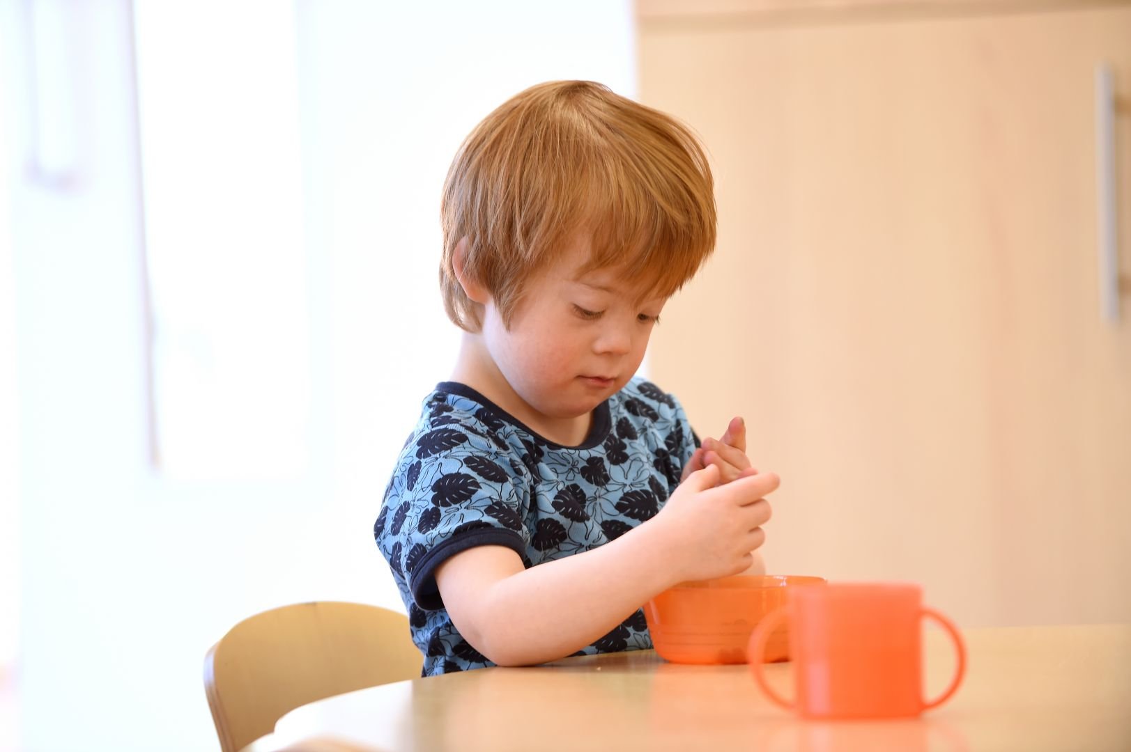 Child holding cup Child holding cup
